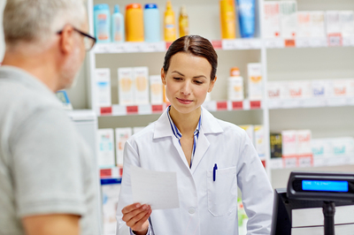 Pharmacist helping a customer.