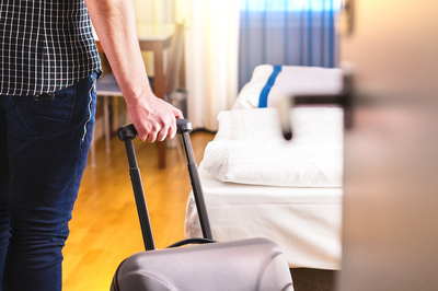 Person moving into a drug rehab with a suitcase.