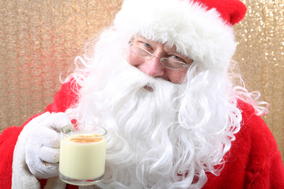 Santa Claus drinking a cup of milk.