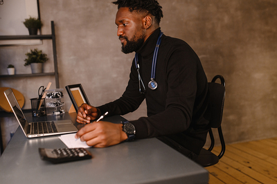 Medical doctor using a laptop for a telemedicine visit.