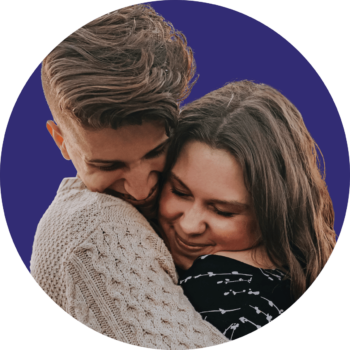 a circle image of two people smiling and hugging